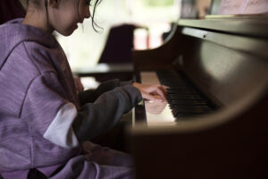 Young student playing piano